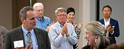 A group of standing, clapping trustees